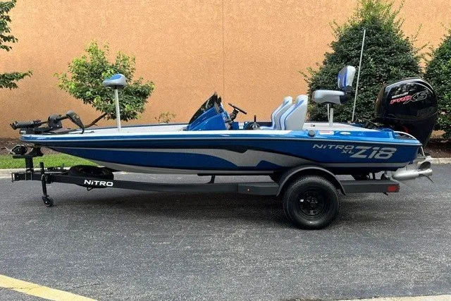 The Image of 2027 Nitro Z18 XL fishing boat with blue and white design on a trailer. - 0