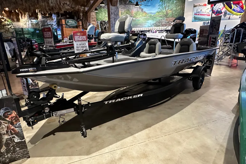 The Image of 2027 Tracker Pro Team 175 boat displayed indoors with Minn Kota trolling motor. - 0