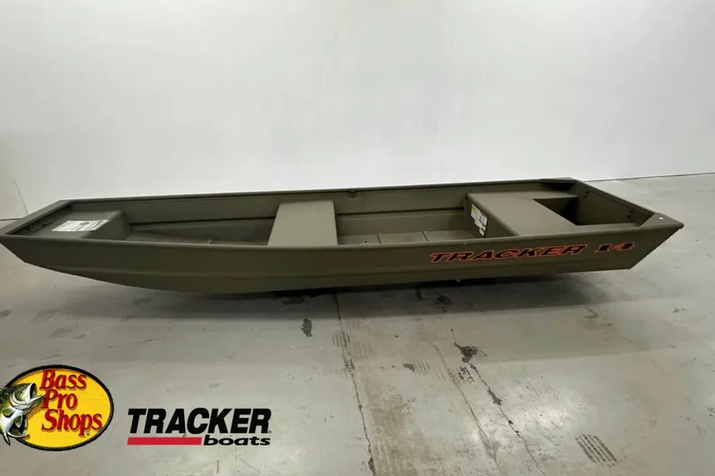 The Image of 2027 Tracker Grizzly 14 Jon boat displayed in showroom with Bass Pro Shops logo. - 0