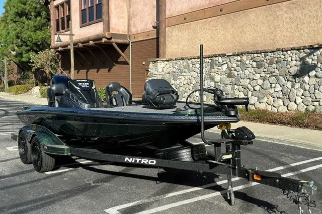 Slide: The Image of 2027 Nitro Z18 XL boat on trailer, parked outdoors near stone building. - 4