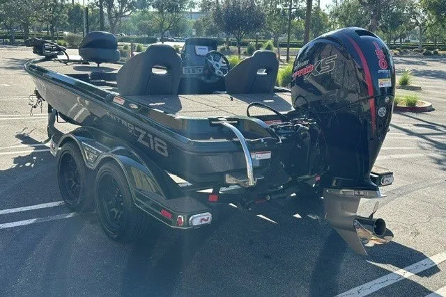 Slide: The Image of 2027 Nitro Z18 XL boat with powerful outboard motor in a parking lot. - 7