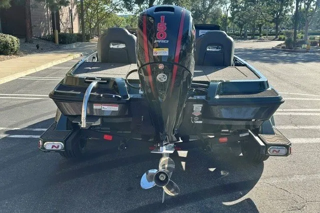 Slide: The Image of 2027 Nitro Z18 XL boat with 150 HP engine, parked outdoors. - 6