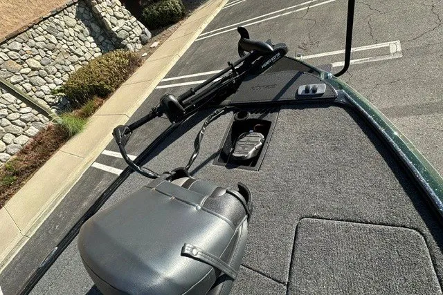 Slide: The Image of 2027 Nitro Z18 XL boat deck with trolling motor and storage compartment in parking lot. - 8