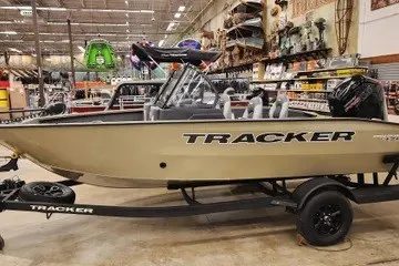 The Image of 2027 Tracker Pro Guide V-175 Combo boat displayed indoors on a trailer. - 0