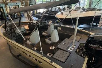Slide: The Image of 2027 Tracker Pro Guide V-175 Combo boat with canopy and Mercury engine in showroom. - 35