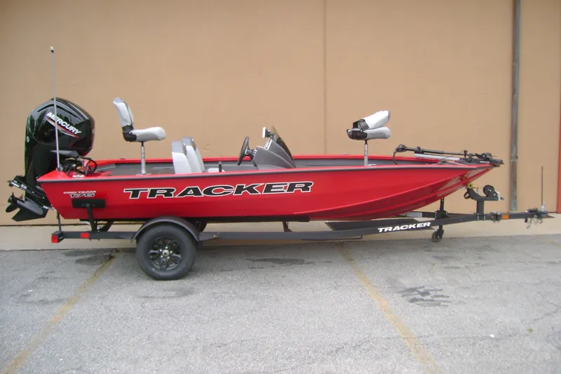 The Image of 2027 Tracker Pro Team 175 boat in red on trailer, side view. - 0