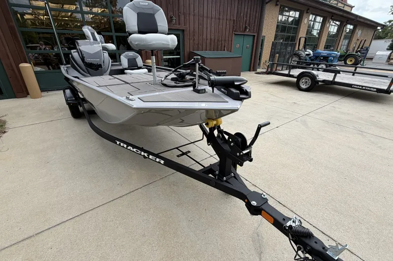 The Image of 2027 Tracker Pro 170 boat on trailer, parked outside a building. - 0