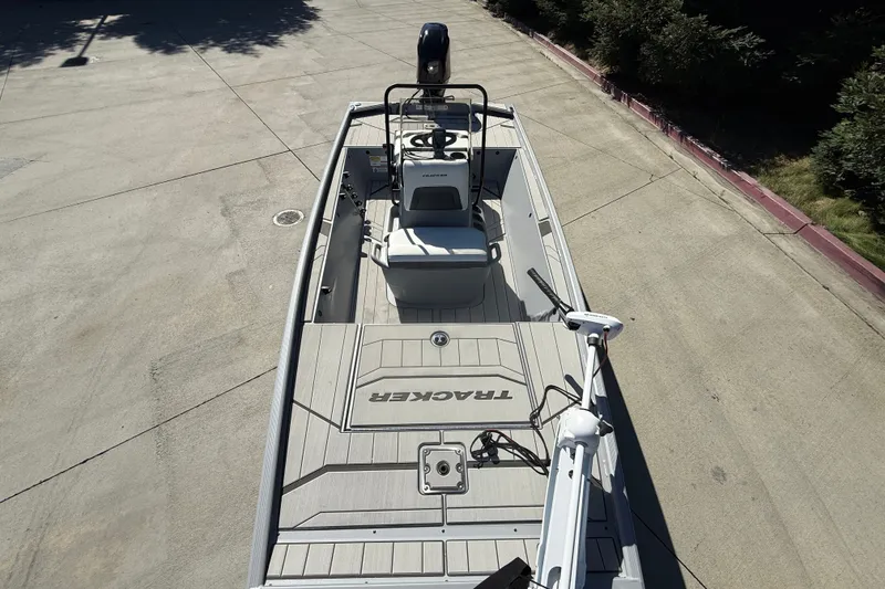 Slide: The Image of The image shows a 2027 Tracker Bass Tracker Classic CC boat on a concrete lot. - 16