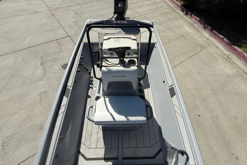Slide: The Image of 2027 Tracker Bass Tracker Classic CC boat interior, featuring steering console and seating. - 13