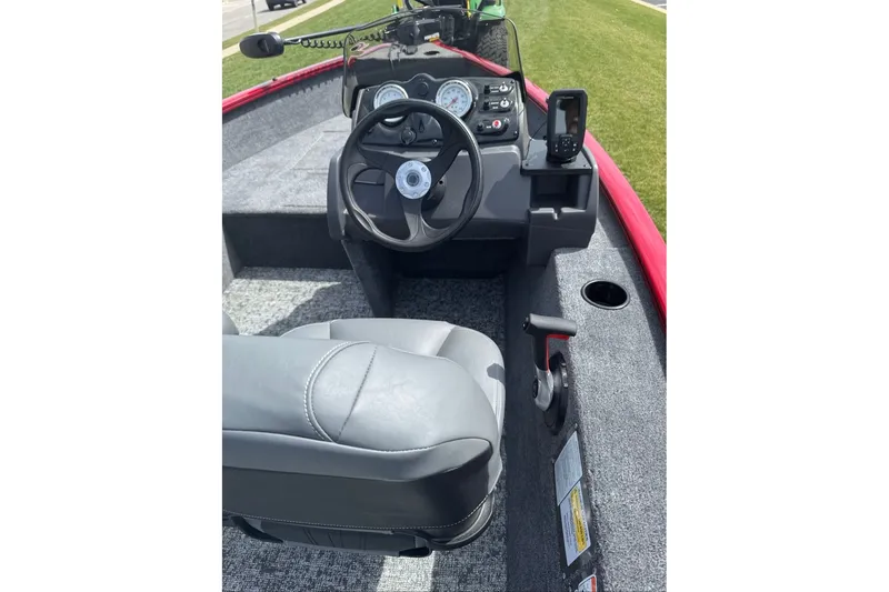 Slide: The Image of Interior of 2027 Tracker Super Guide V-16 SC boat with steering wheel and controls. - 16