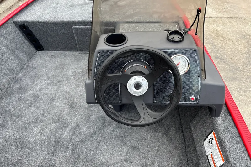 Slide: The Image of 2027 Tracker Bass Tracker Classic XL boat dashboard with steering wheel and gauge. - 15