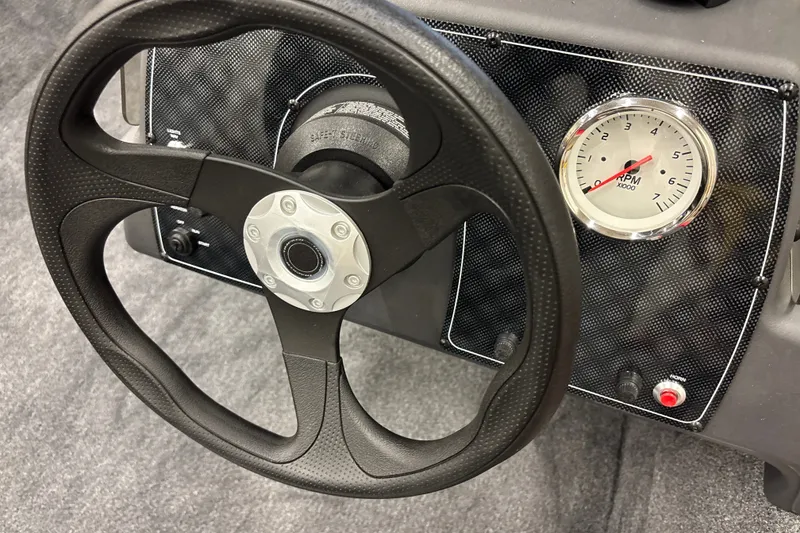 Slide: The Image of Steering wheel and RPM gauge of 2027 Tracker Bass Tracker Classic XL boat. - 16