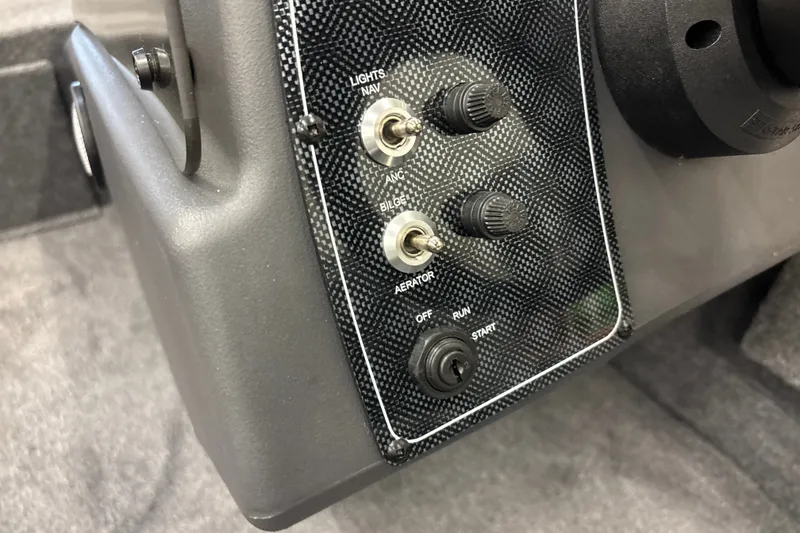 Slide: The Image of Control panel of 2027 Tracker Bass Tracker Classic XL boat with switches and ignition. - 17