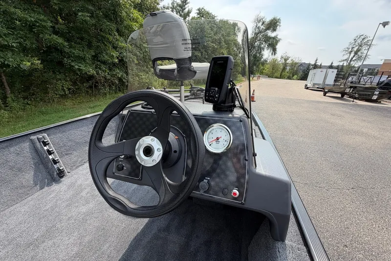 Slide: The Image of 2027 Tracker Bass Tracker Classic XL boat dashboard with steering wheel and gauge. - 22