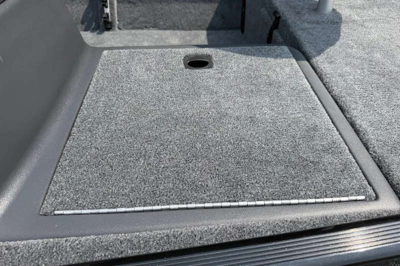 Slide: The Image of Carpeted deck of 2027 Tracker Bass Tracker Classic XL boat, featuring storage compartment. - 18