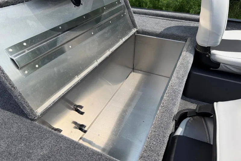 Slide: The Image of Open storage compartment in 2027 Tracker Bass Tracker Classic XL boat interior. - 15