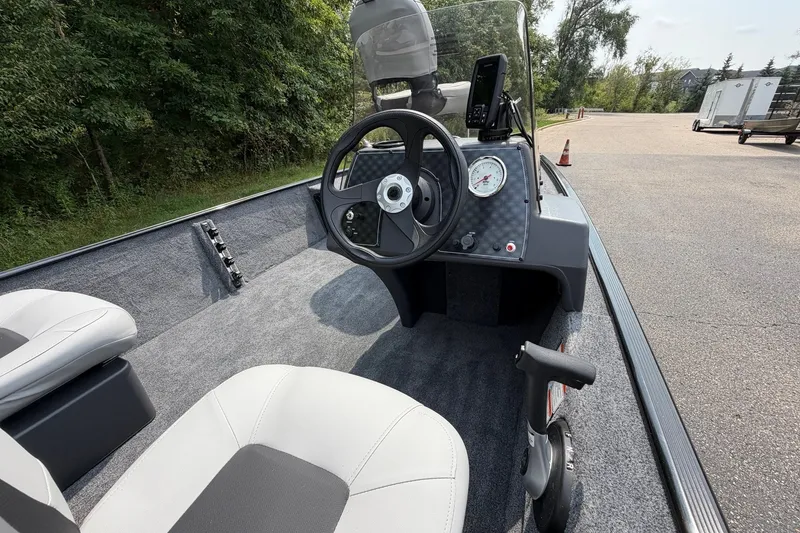 Slide: The Image of 2027 Tracker Bass Tracker Classic XL boat interior with steering wheel and dashboard. - 23