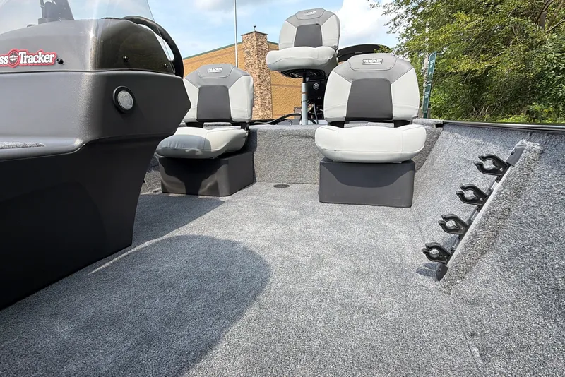 Slide: The Image of 2027 Tracker Bass Tracker Classic XL boat interior with seating and rod holders. - 17