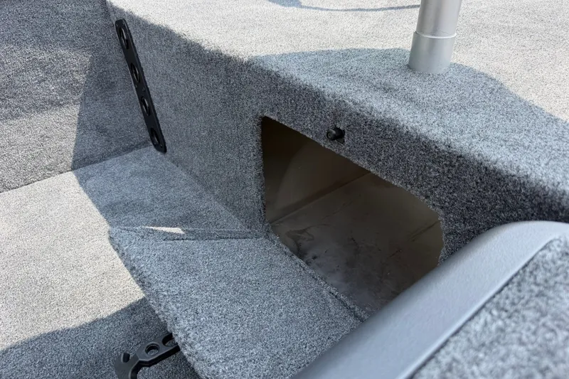 Slide: The Image of 2027 Tracker Bass Tracker Classic XL boat interior storage compartment with gray carpet. - 21