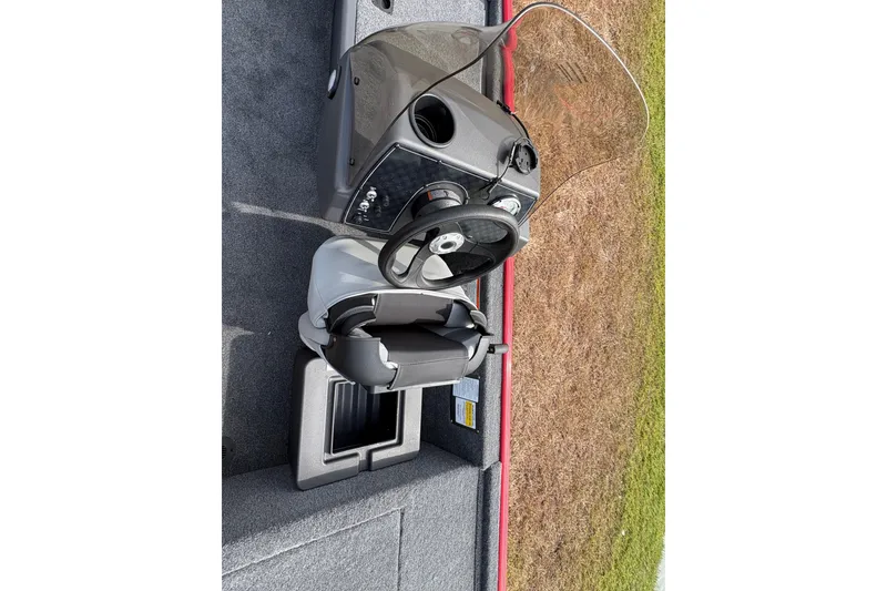 Slide: The Image of 2027 Tracker Bass Tracker Classic XL boat cockpit with steering wheel and seat. - 85