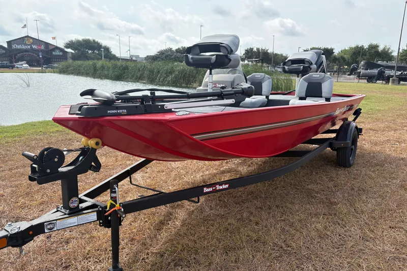 Slide: The Image of 2027 Tracker Bass Tracker Classic XL boat on trailer by a pond. - 74