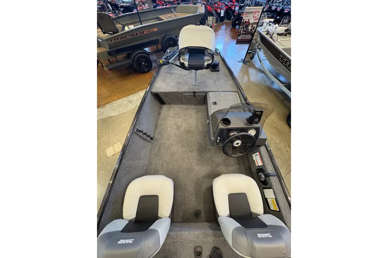 Slide: The Image of 2027 Tracker Bass Tracker Classic XL boat interior with seating and steering console. - 22