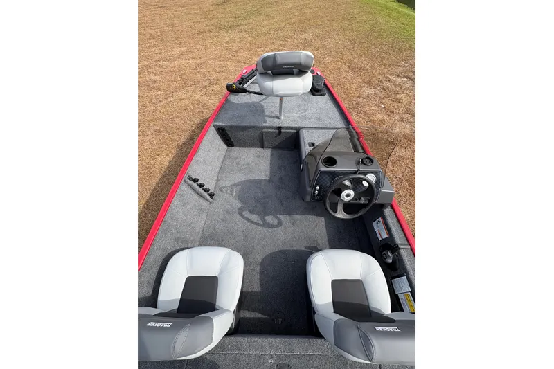 Slide: The Image of 2027 Tracker Bass Tracker Classic XL boat interior with steering wheel and seating. - 81