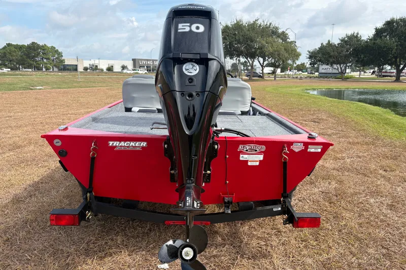 Slide: The Image of 2027 Tracker Bass Tracker Classic XL boat with Mercury 50 engine, parked on grass. - 77