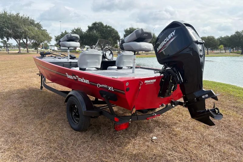 Slide: The Image of 2027 Tracker Bass Tracker Classic XL boat with Mercury engine by a lake. - 76