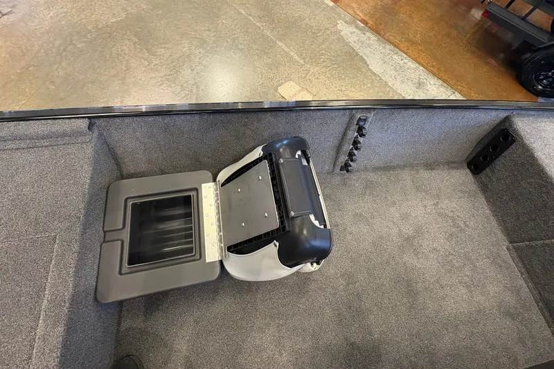 Slide: The Image of Interior of 2027 Tracker Bass Tracker Classic XL boat with storage compartment open. - 23