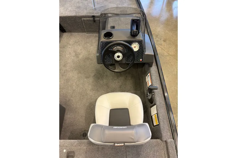 Slide: The Image of 2027 Tracker Bass Tracker Classic XL boat interior with steering wheel and seat. - 24