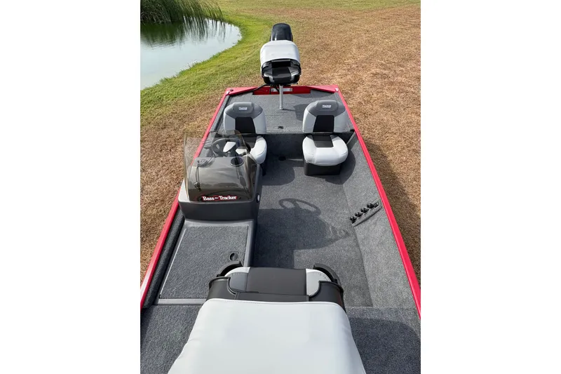 Slide: The Image of 2027 Tracker Bass Tracker Classic XL boat interior with seating and steering console. - 83