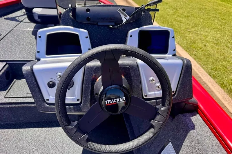 Slide: The Image of Steering wheel of 2027 Tracker Pro Team 175 boat, featuring modern dashboard controls. - 14