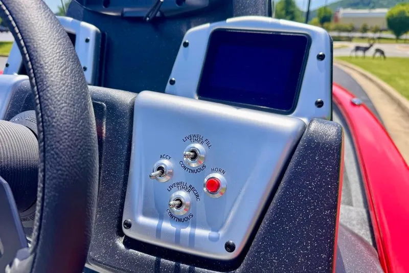 Slide: The Image of Dashboard controls of a 2027 Tracker Pro Team 175 boat, featuring switches and a display. - 17