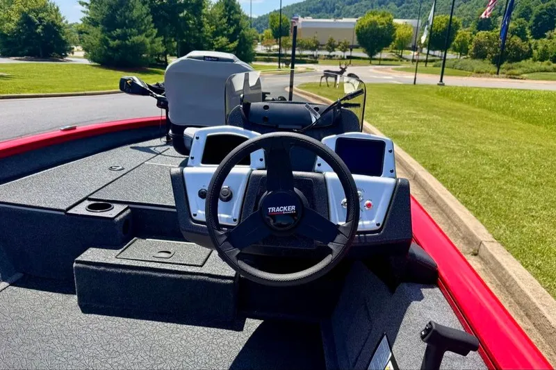 Slide: The Image of 2027 Tracker Pro Team 175 boat dashboard with steering wheel and control panel. - 18