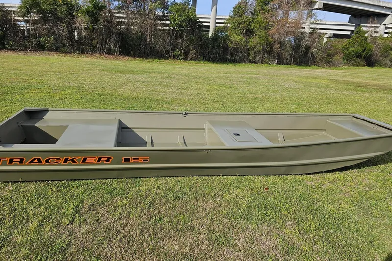The Image of 2027 Tracker Grizzly 15 Jon boat on grass, showcasing its sleek design. - 0