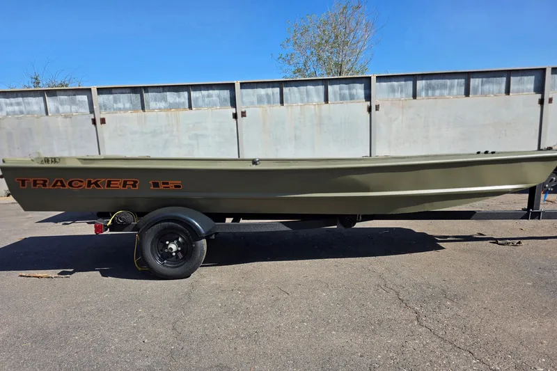 The Image of 2027 Tracker Grizzly 15 Jon boat on trailer, parked outdoors. - 0
