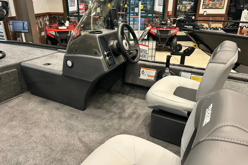 Slide: The Image of 2027 Tracker Bass Tracker Classic XL boat interior with steering console and seating. - 62