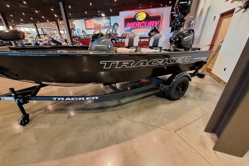The Image of 2027 Tracker Super Guide V-16 SC boat displayed indoors with Mercury engine. - 0