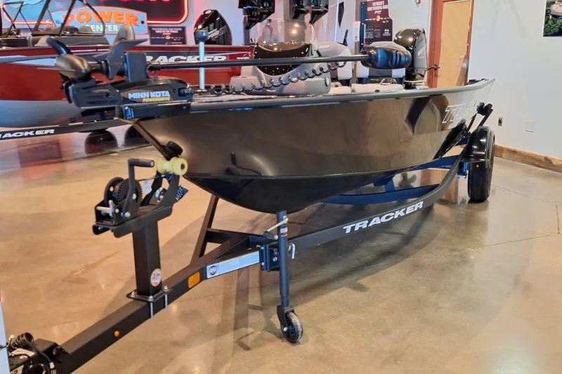 Slide: The Image of 2027 Tracker Super Guide V-16 SC boat on display with Minn Kota motor. - 32