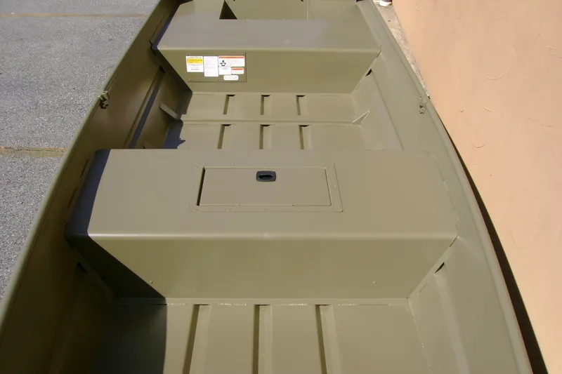 Slide: The Image of 2027 Tracker Grizzly 15 Jon boat interior, featuring durable seating and storage compartments. - 13