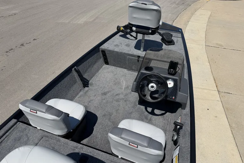 Slide: The Image of 2027 Tracker Bass Tracker Classic XL boat interior with steering wheel and seating. - 18