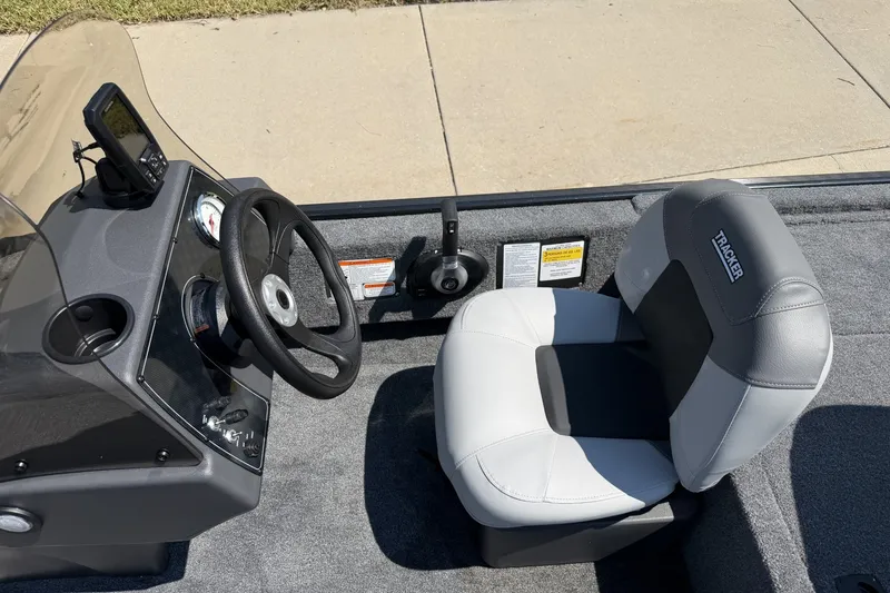 Slide: The Image of 2027 Tracker Bass Tracker Classic XL boat interior with steering wheel and seat. - 15