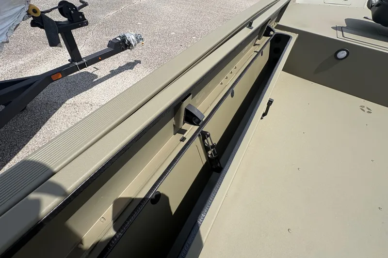 Slide: The Image of 2027 Tracker Grizzly 1654 T Sportsman boat interior with storage compartment open. - 13