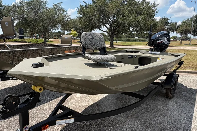 The Image of 2027 Tracker Grizzly 1654 T Sportsman boat on trailer, parked outdoors. - 0
