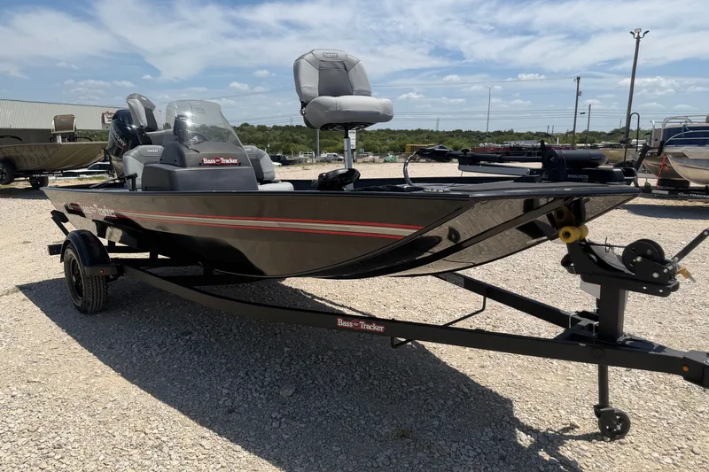 The Image of 2027 Tracker Bass Tracker Classic XL boat on trailer under clear sky. - 0