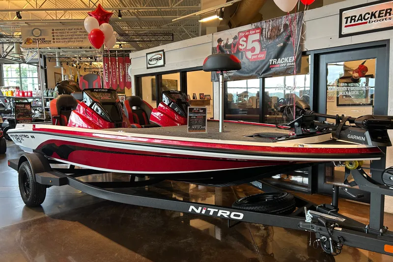 The Image of 2027 Nitro Z18 XL Pro boat displayed in showroom with red and white design. - 0