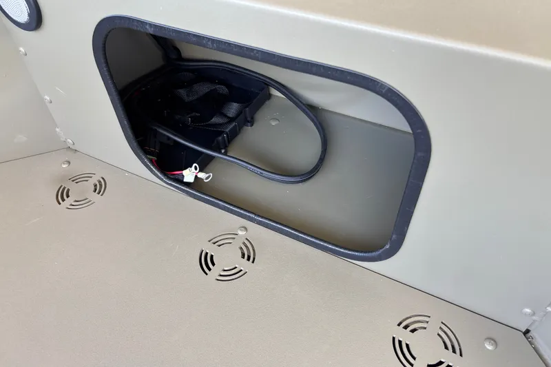 Slide: The Image of Battery compartment of 2027 Tracker Grizzly 1654 T Sportsman boat, featuring ventilation grilles. - 13