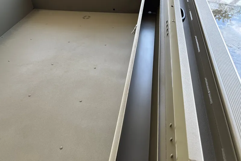 Slide: The Image of Interior view of 2027 Tracker Grizzly 1654 T Sportsman boat, showcasing storage compartment. - 19