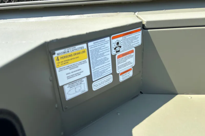 Slide: The Image of 2027 Tracker Grizzly 1654 T Sportsman boat capacity and safety labels. - 17